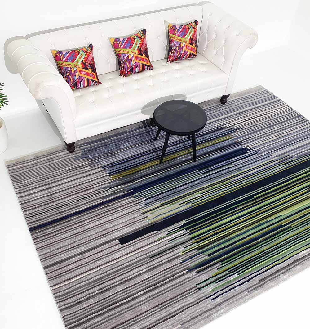 Rectangular multi-color rug placed in a living space, acting as a functional room anchor with its rich palette.