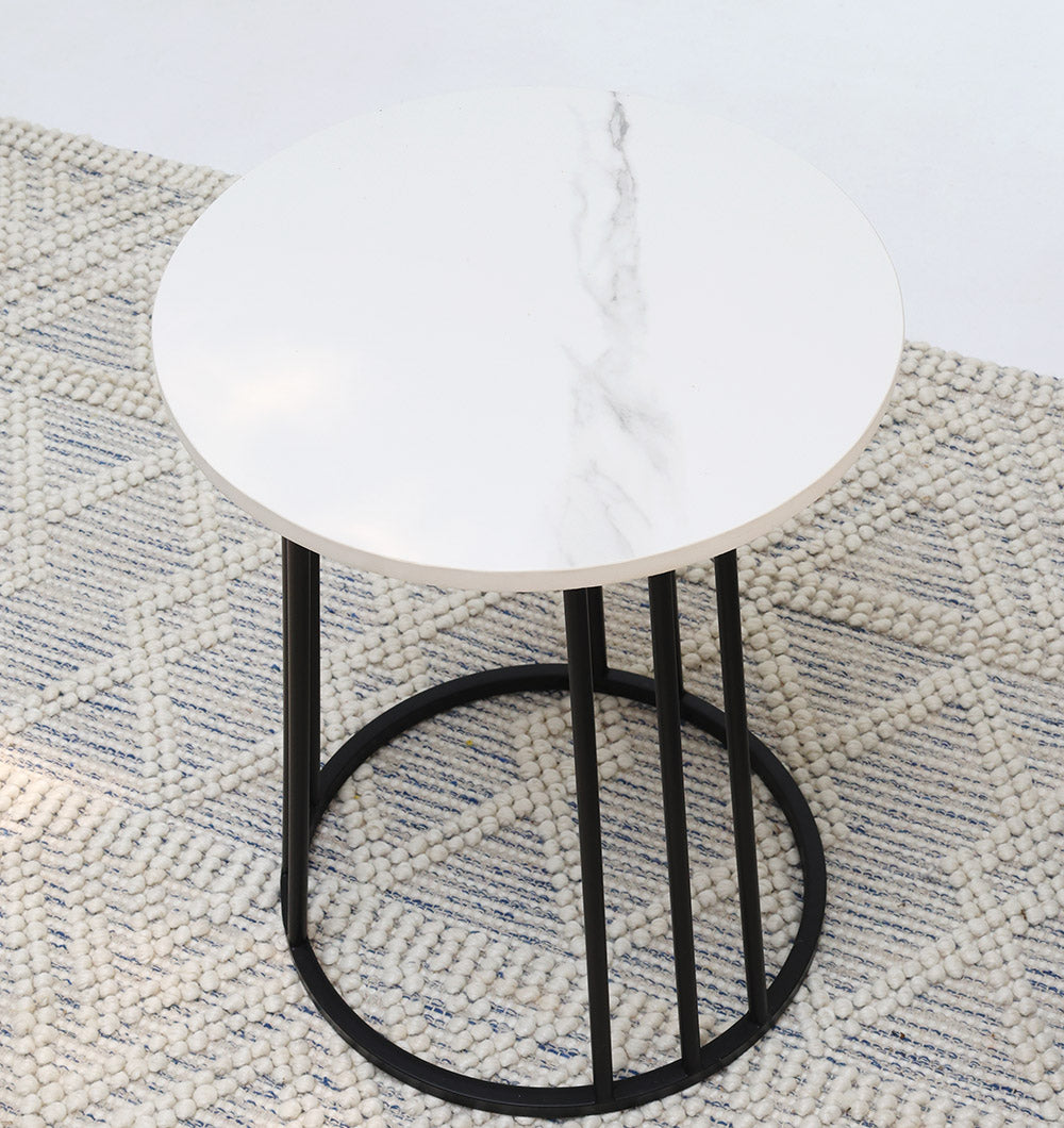 Round marble table with an iron stand enhancing a modern interior with its refined style and timeless design.
