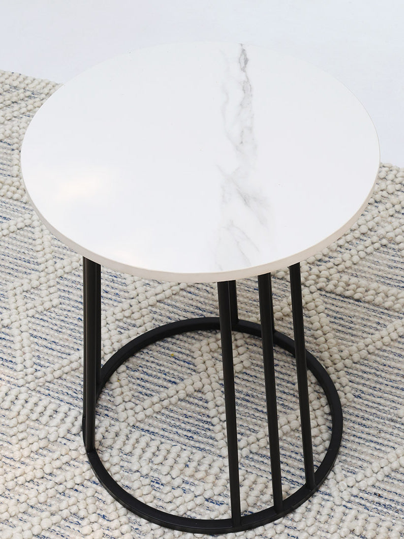Round marble table with an iron stand enhancing a modern interior with its refined style and timeless design.