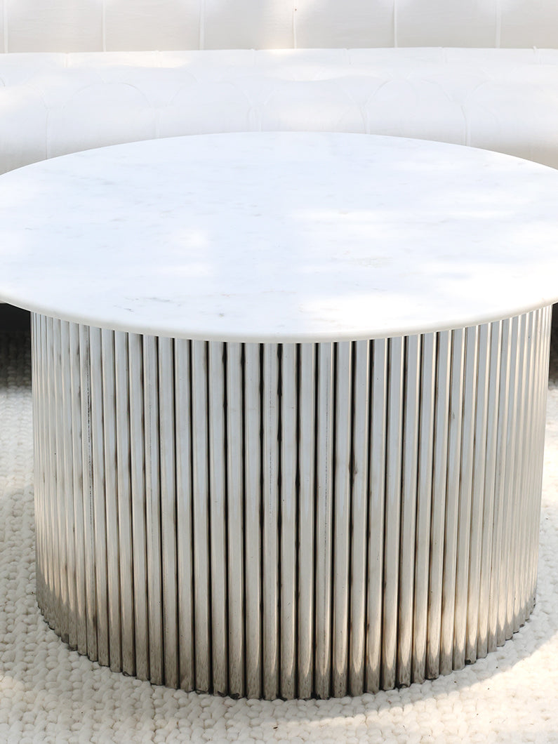 Luna coffee table enhancing a contemporary living space with its durable marble top and stainless steel frame.