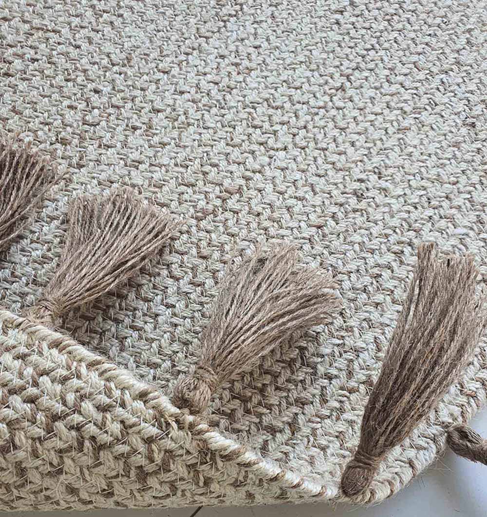 Backside of the round jute rug, confirming the solid construction and tight stitching of the hand-woven braid.