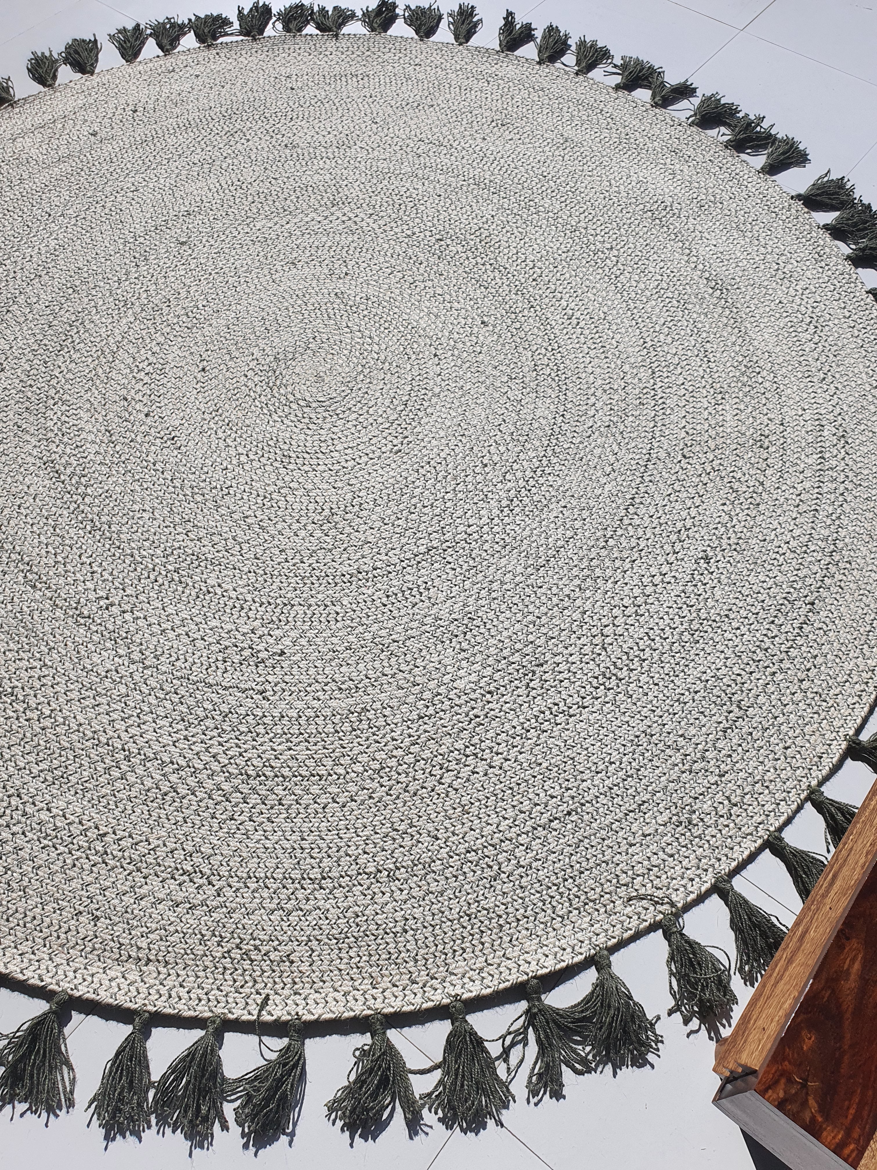 Artisan-made braided round rug in a modern setting, adding rustic charm and natural color to the space.