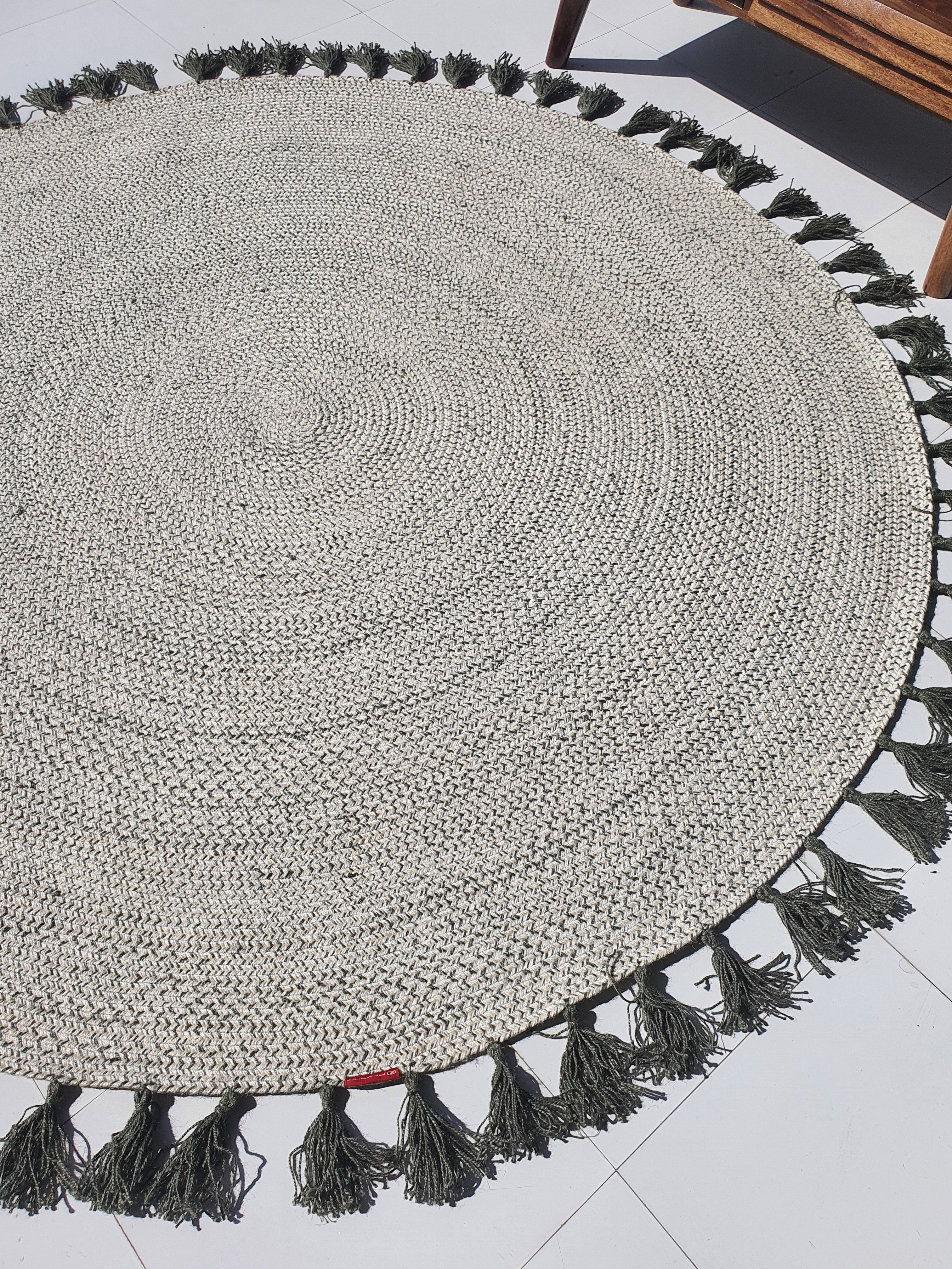 Full view of the round jute rug, demonstrating the circular shape and flat surface of the natural fiber construction.