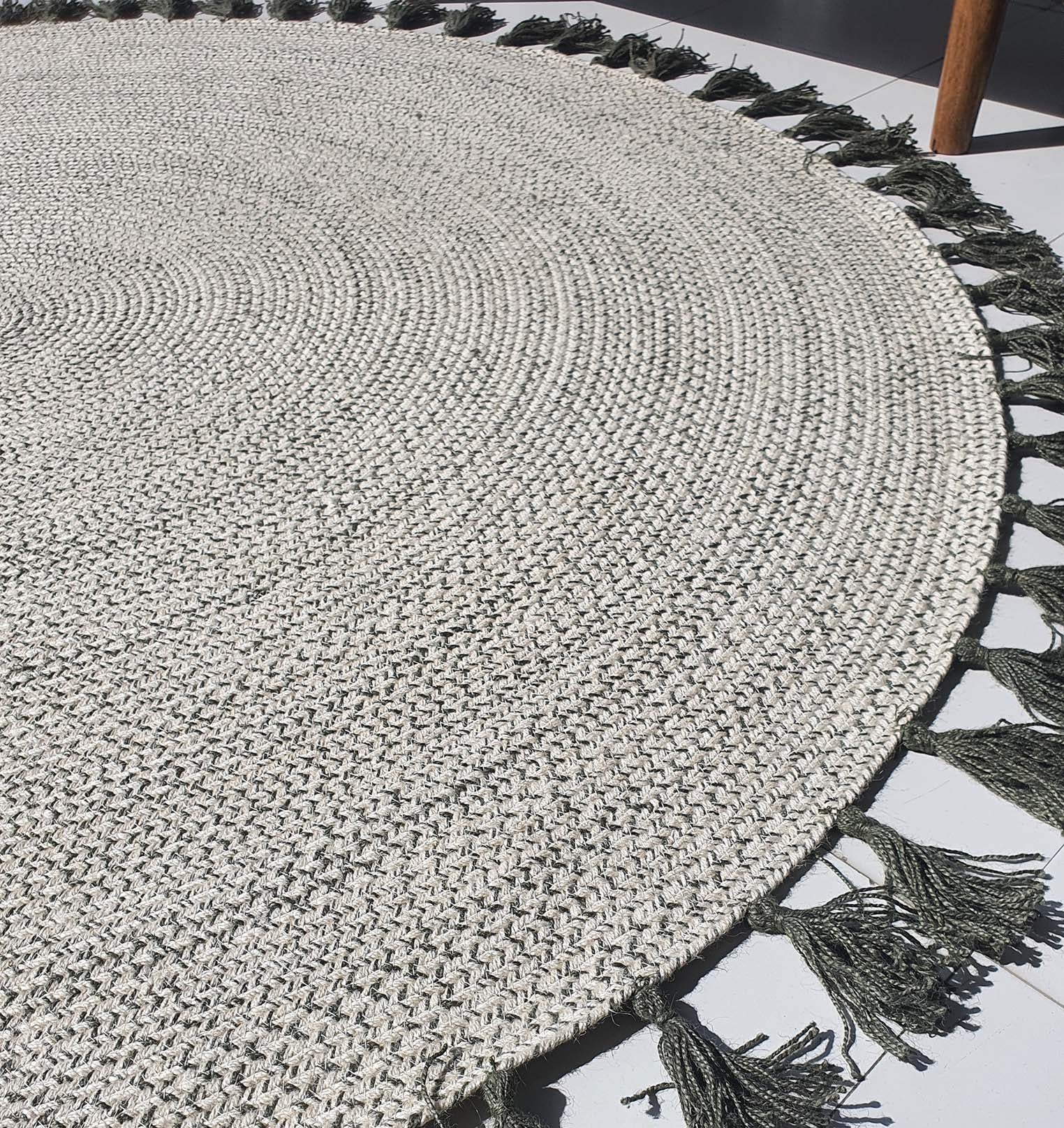 Handmade jute rug providing a neutral base and earthy tones, serving as a functional grounding layer.