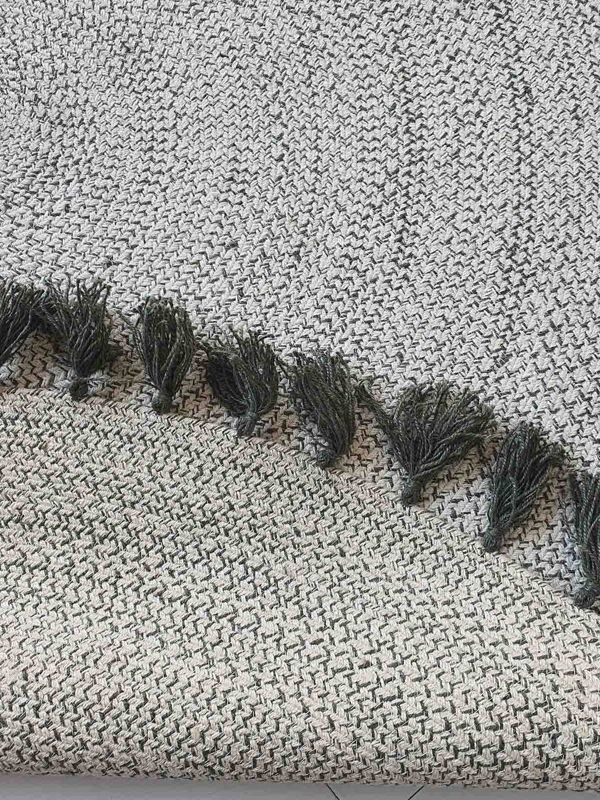 Backside of the round braided rug, confirming the solid construction and meticulous braiding of the jute material.