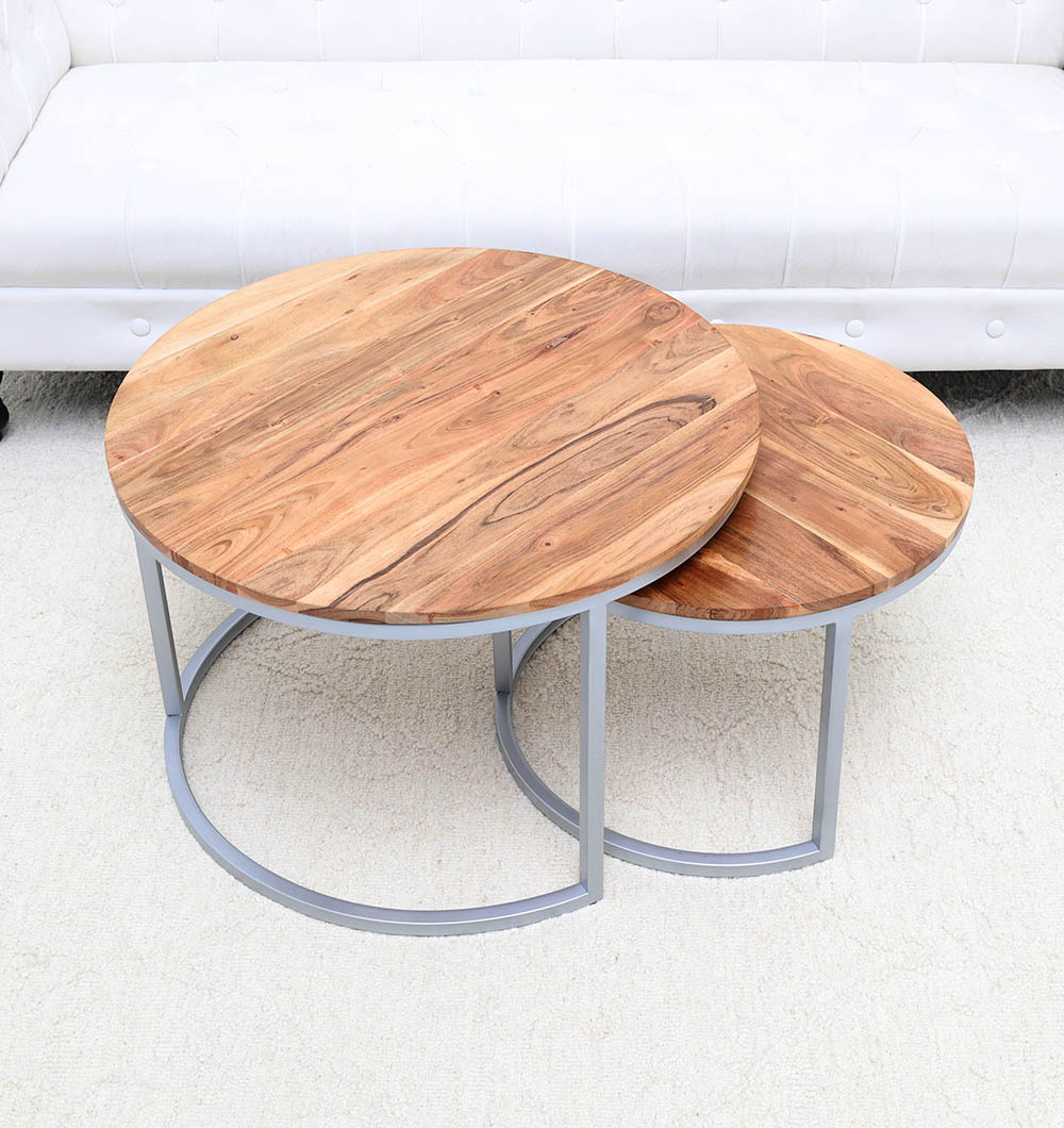 Angled view of the round wooden tops and metal frame, adding functional furniture and natural beauty to the interior.