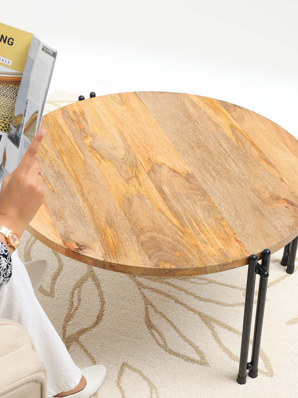 Round center table serving as a stylish focal accent piece, blending modern and industrial design in the living room.