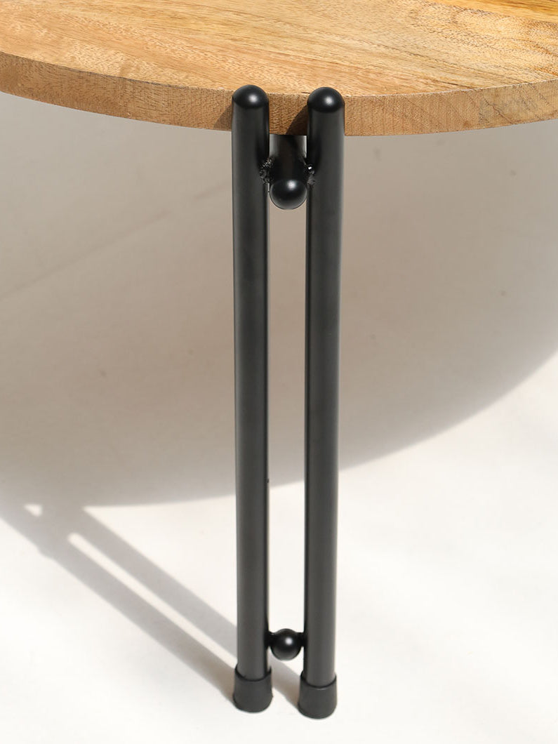 Side close-up detailing the sturdy black iron legs, creating a sleek industrial contrast and durability.