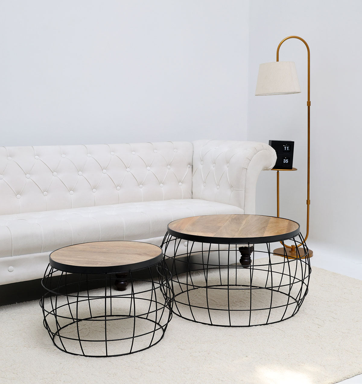 Industrial nesting side tables with a solid wood top and sleek black metal wire base, adding functional style to the home.