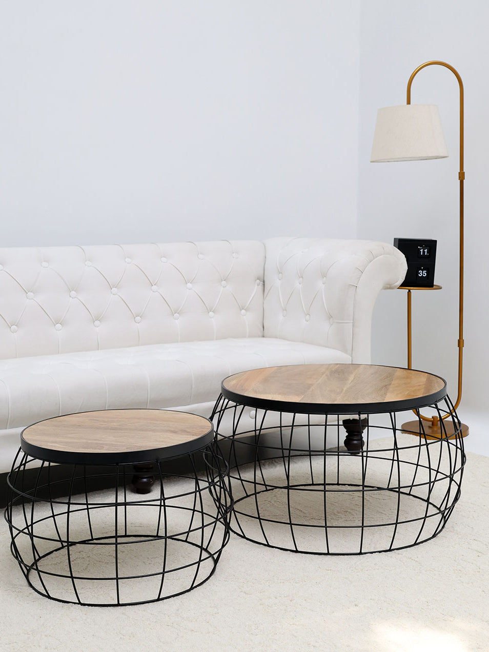 Industrial nesting side tables with a solid wood top and sleek black metal wire base, adding functional style to the home.
