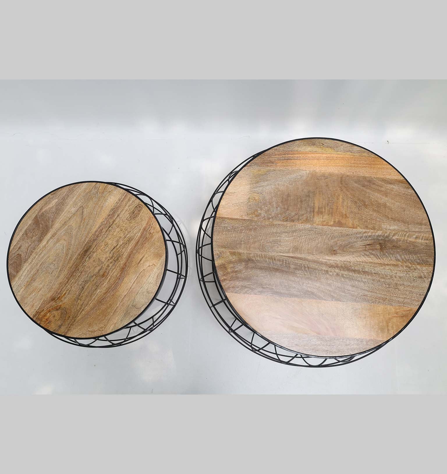 Top-down view of the round solid wood tops, contrasting beautifully with the sturdy black metal frame design.