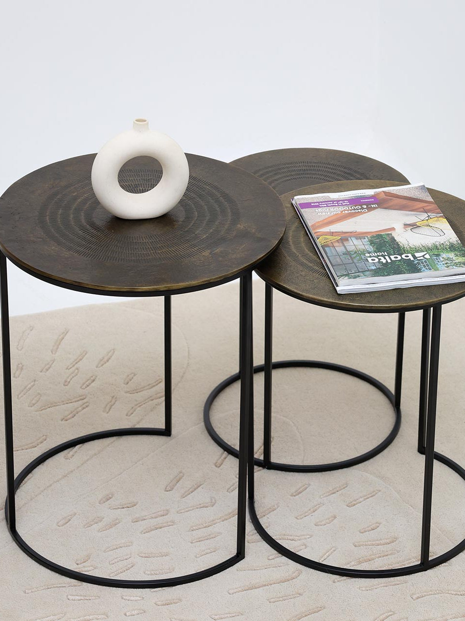 Modern nesting tables serving as a functional centerpiece, bringing timeless elegance to the living space décor.