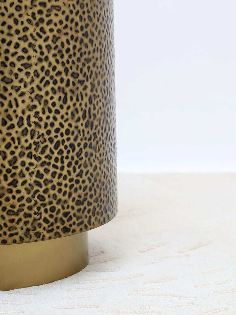 Side profile of the cylindrical table, showcasing its compact form and elegant textured leopard-inspired pattern.