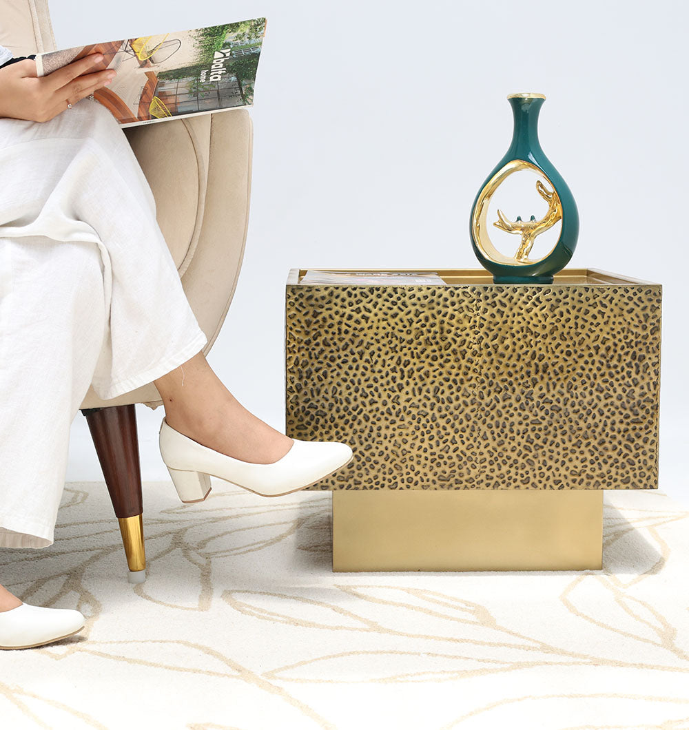 Luxury square iron side table with a brass antique finish, adding a bold statement to the living room decor.