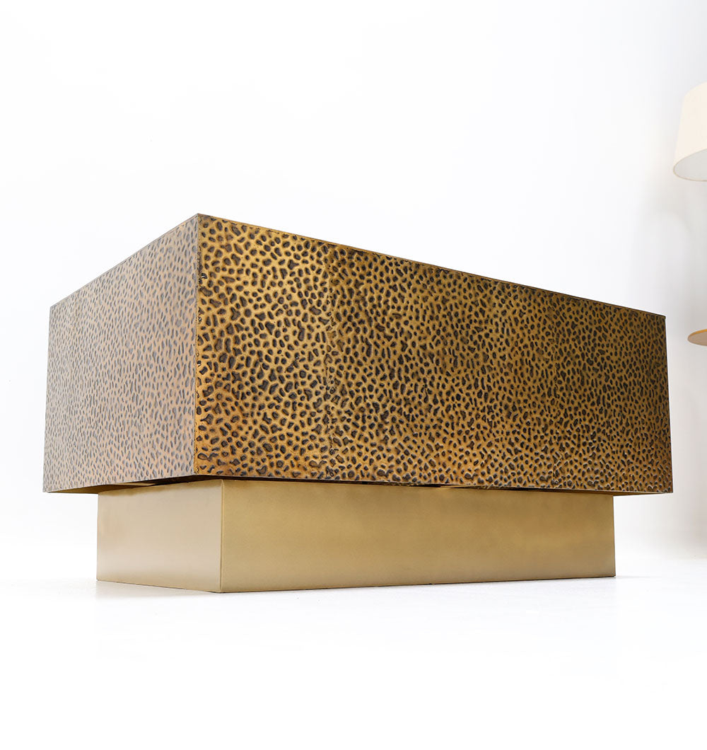 Make a statement with this rectangular accent table in golden metal and tactile design.
