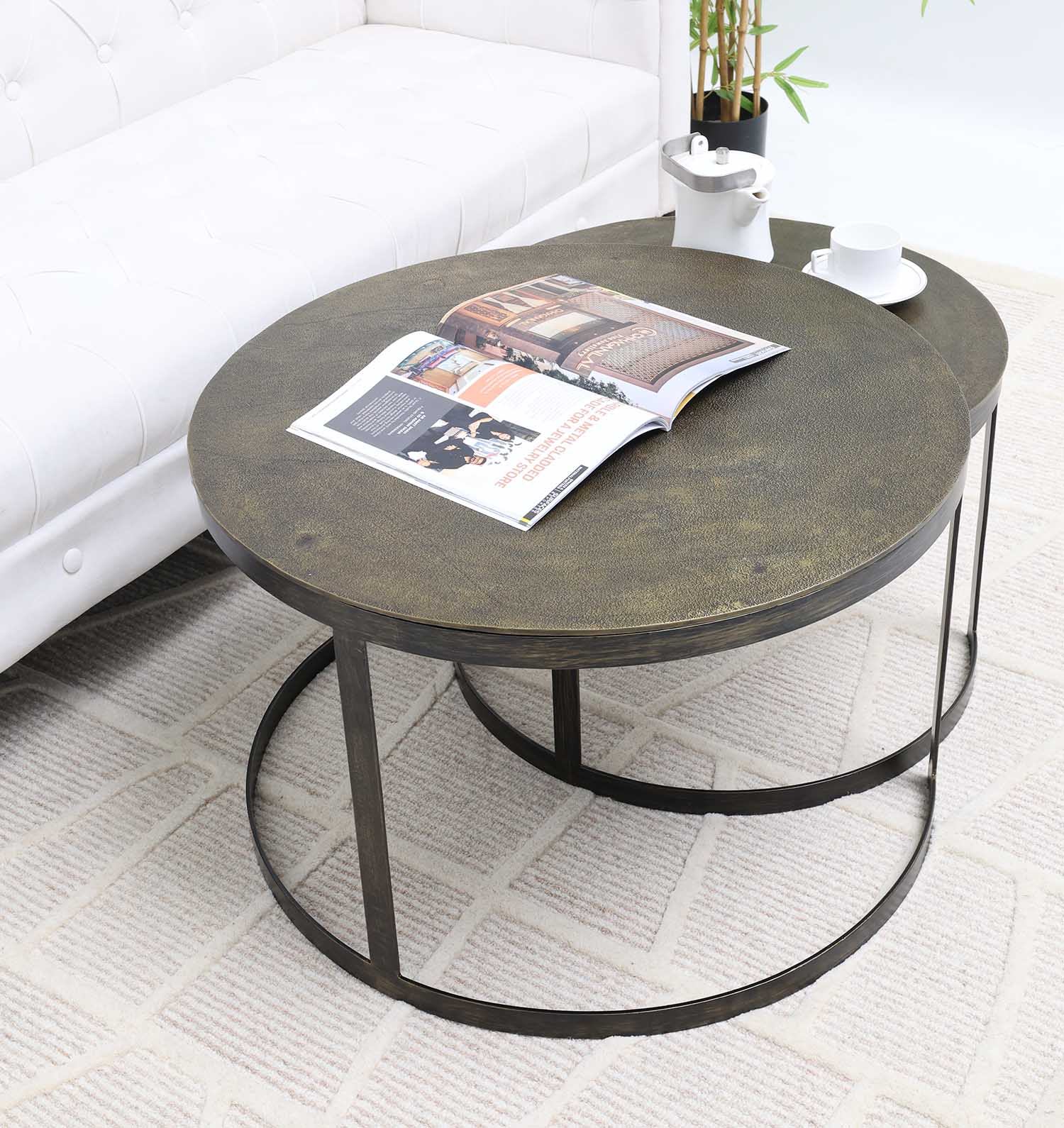 Elegant round nesting tables crafted from natural wood and black metal.