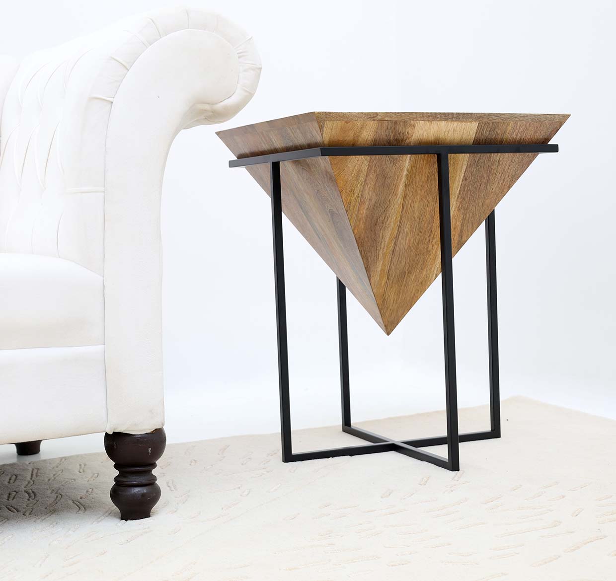 Minimalist side table with natural wood surface and sturdy iron support.
