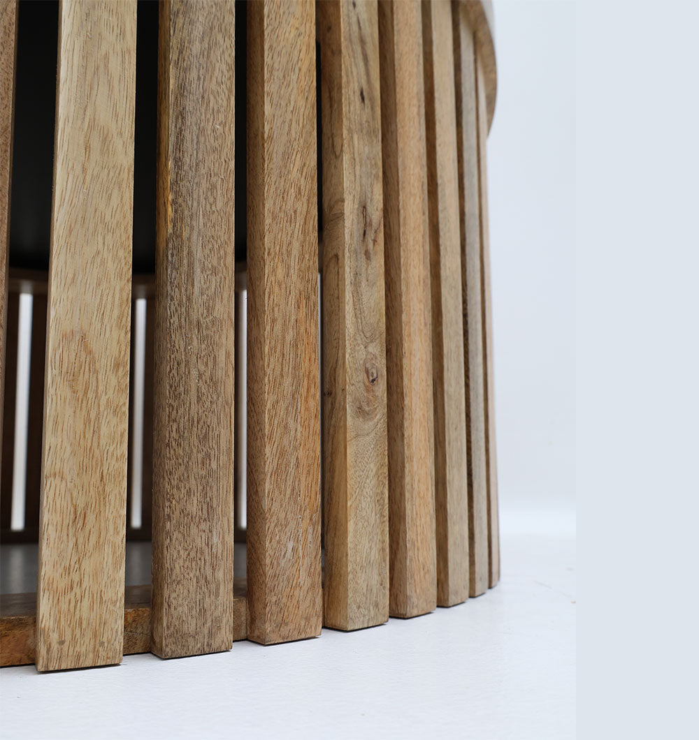 Contemporary round accent table with natural wood finish and black metal frame.