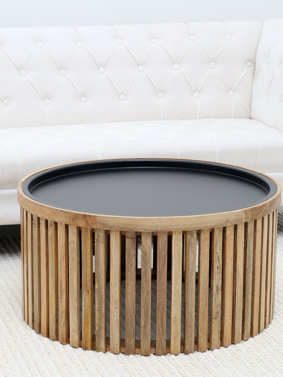Luxury round coffee table with slatted wooden top and iron base, ideal for stylish living room decor.