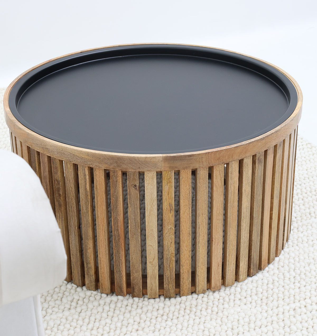 Modern slatted wood coffee table with iron legs, designed for elegant interiors.