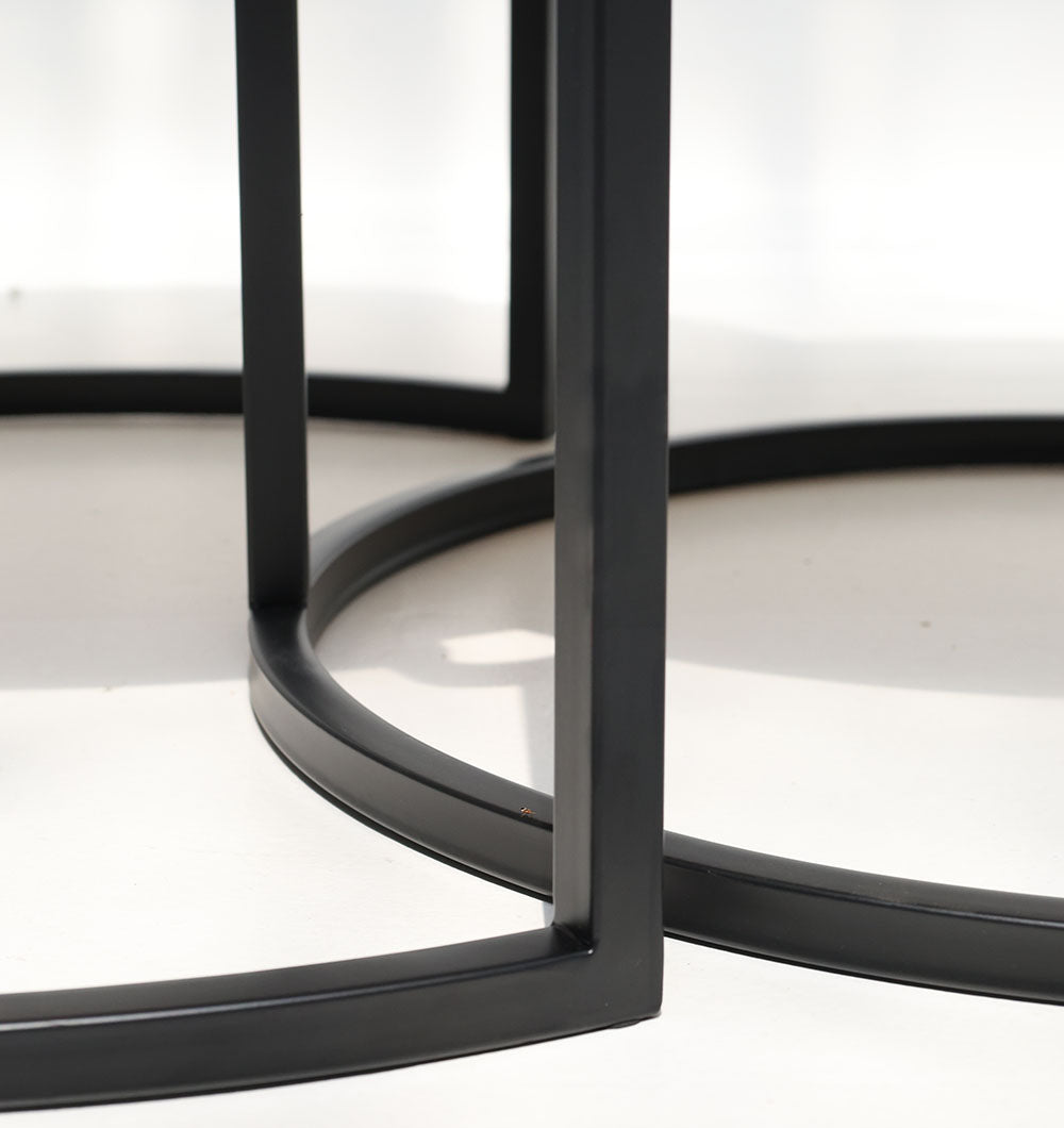 Stylish nesting coffee tables with round wood design and sturdy metal frames.