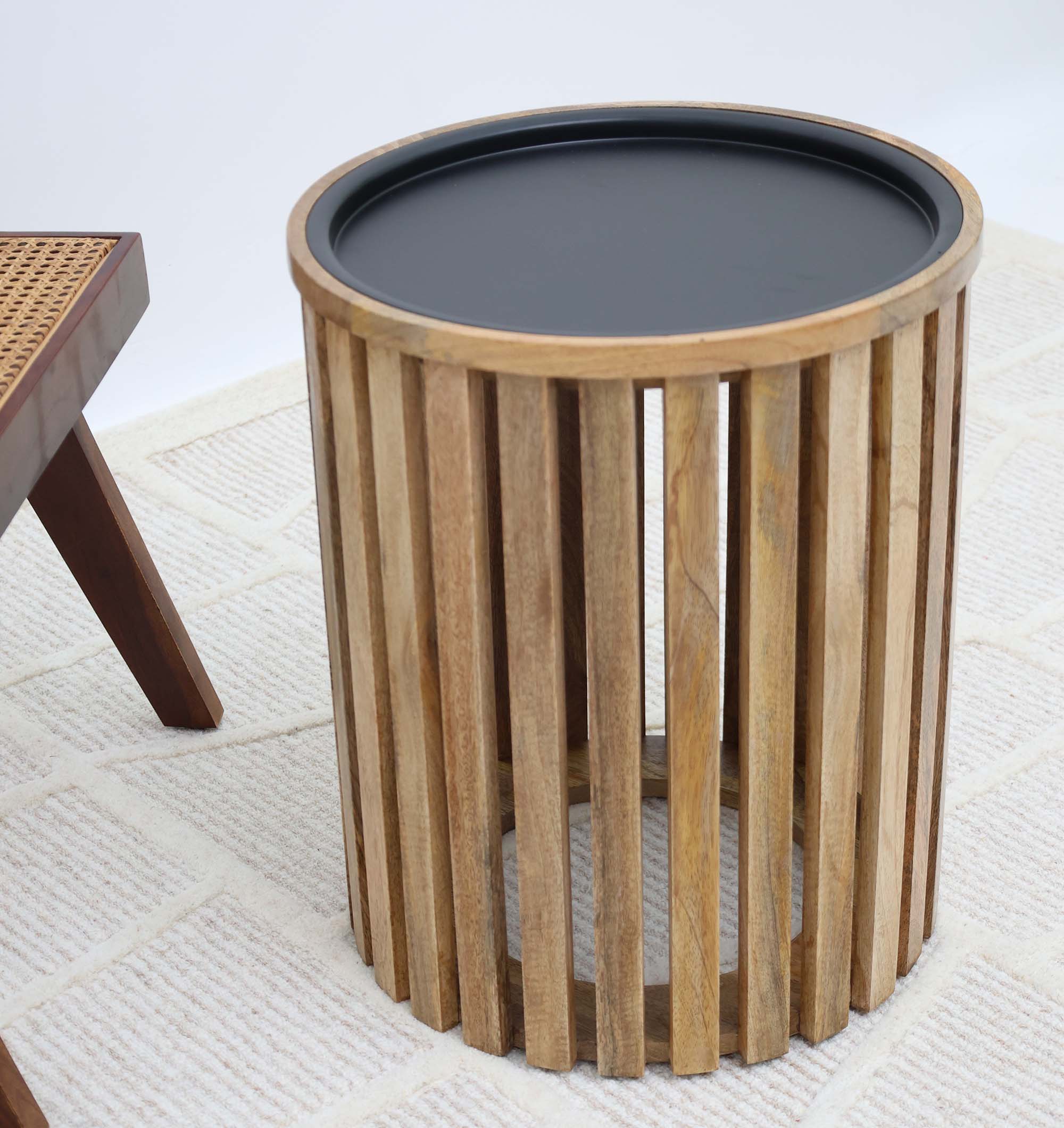 Stylish round coffee table featuring vertical wooden slats and a sleek iron frame.