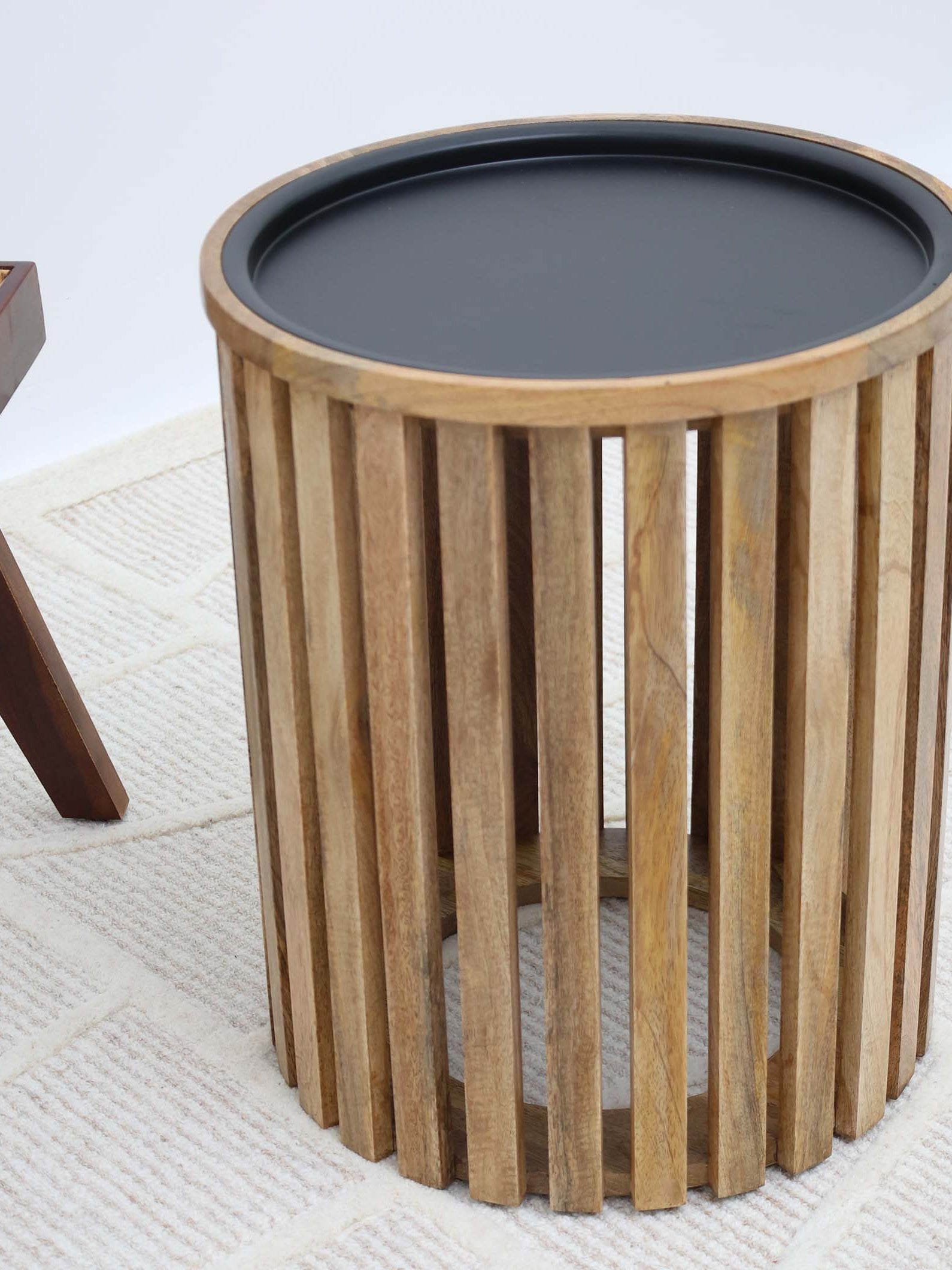 Stylish round coffee table featuring vertical wooden slats and a sleek iron frame.