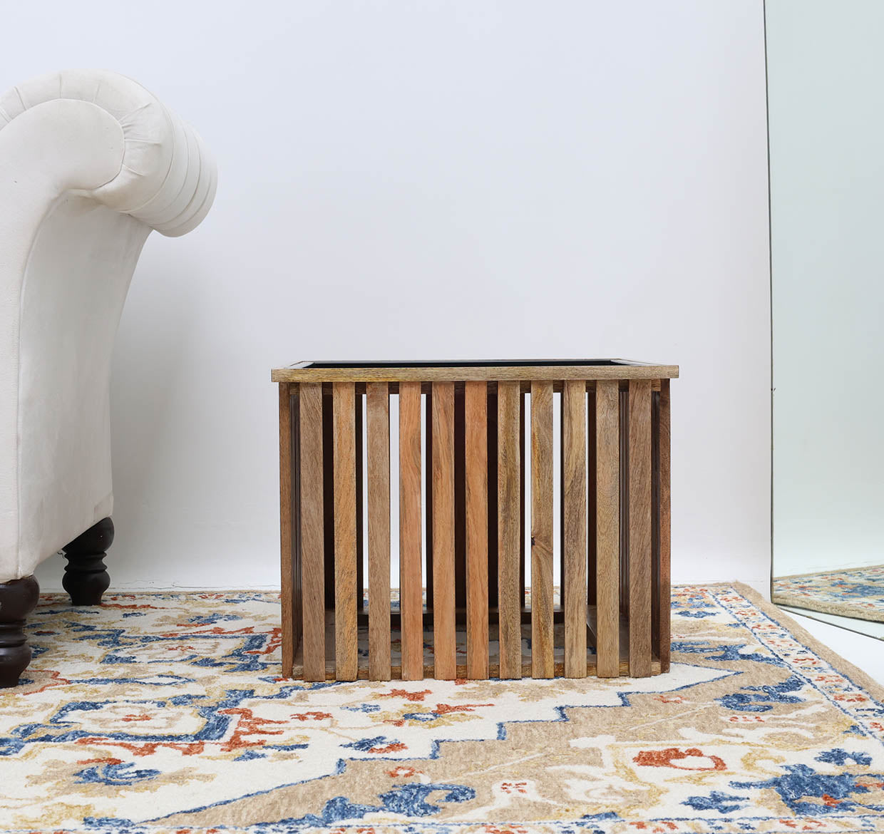Contemporary accent table with square wooden top and industrial iron legs.