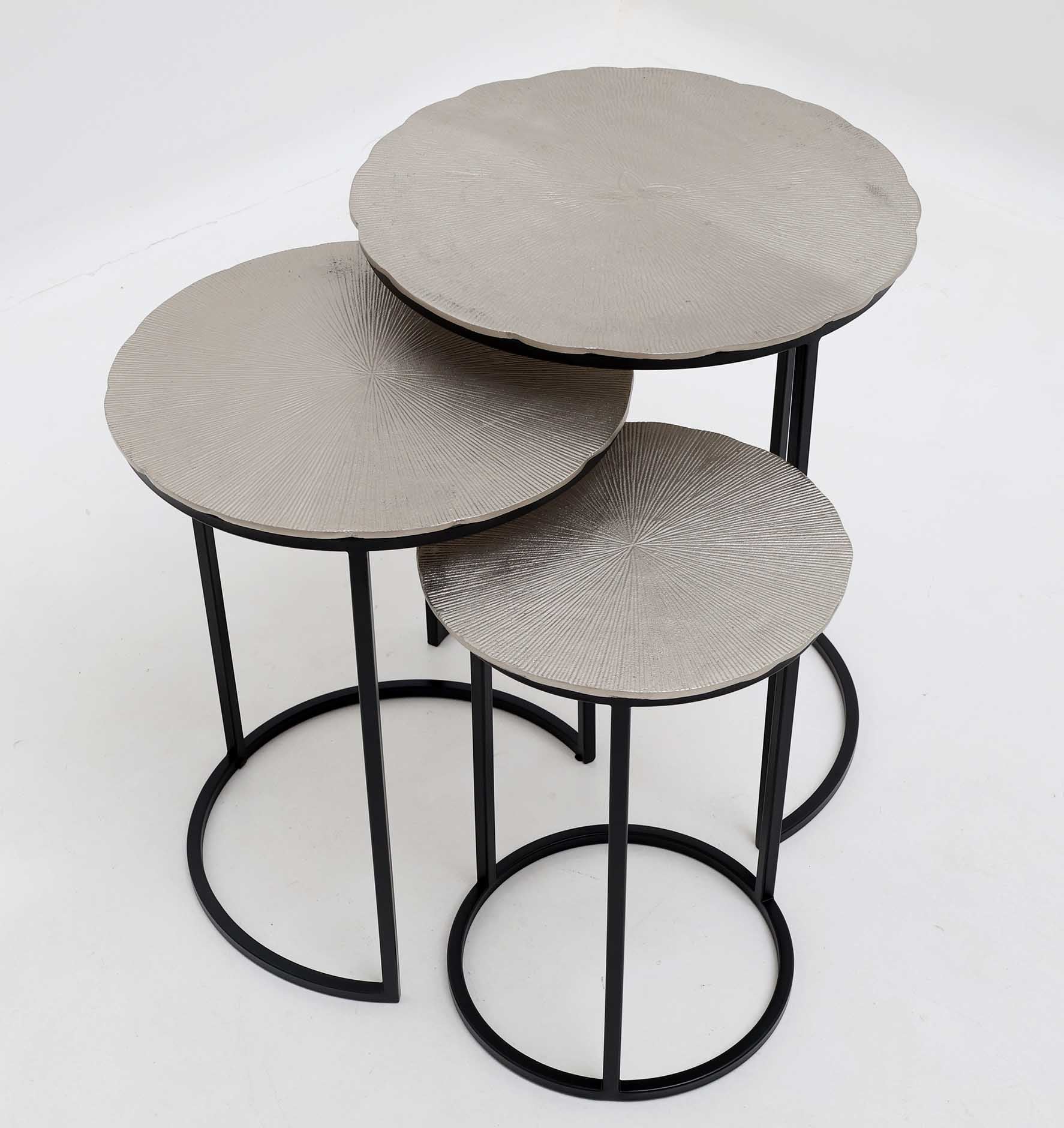 Contemporary side table trio with round brass tops and industrial grey iron bases.