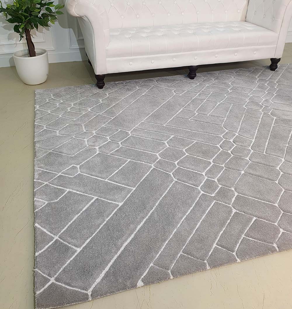 Rectangular multi-color carpet placed in a high-traffic area, demonstrating its low-shedding and easy-to-maintain synthetic pile.