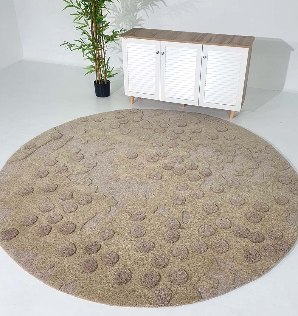 Round rug placed as a central floor piece in a living room, demonstrating the resilient material and stylish look.