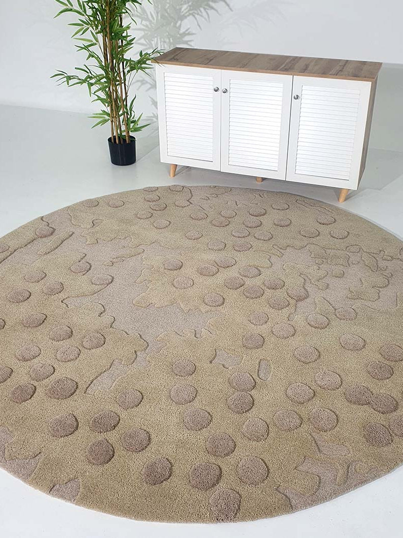 Round rug placed as a central floor piece in a living room, demonstrating the resilient material and stylish look.