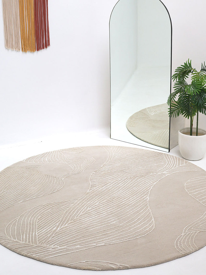 Round rug in a striking beige hue, bringing a bold statement and sophisticated design to the living space.
