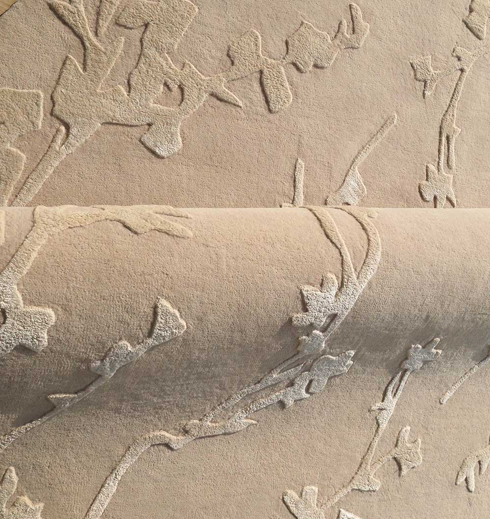 Detailed shot of the refined texture of the handmade rug, showcasing the elegant neutral beige tone.