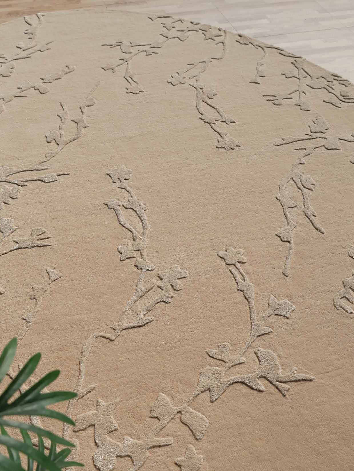 Side angle of the irregular-shaped rug in the beige color palette, showcasing the handmade edge and refined craftsmanship.