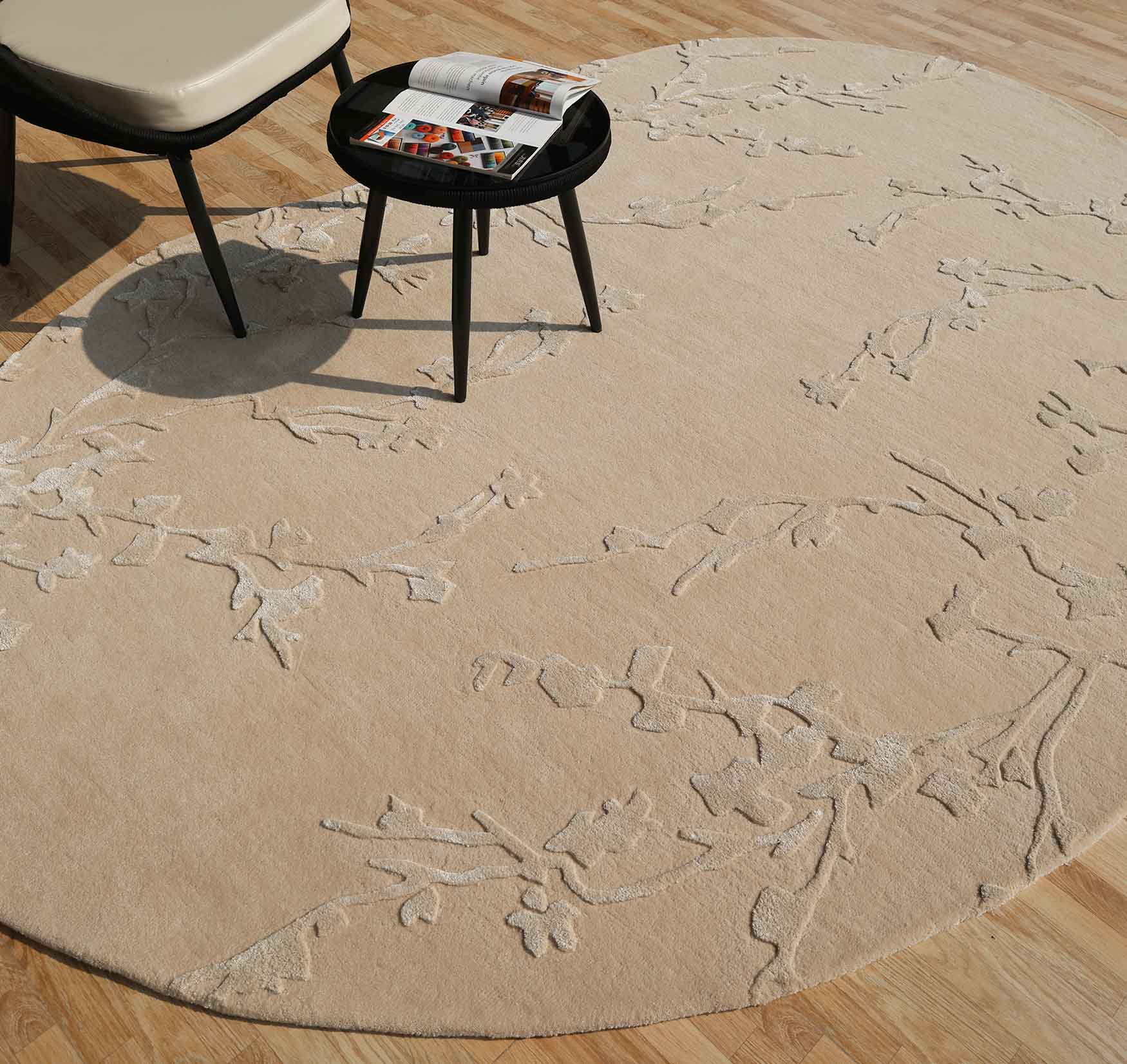 Irregular decorative rug placed beneath a chair and table, offering comfort underfoot and durable quality for high-traffic spaces.