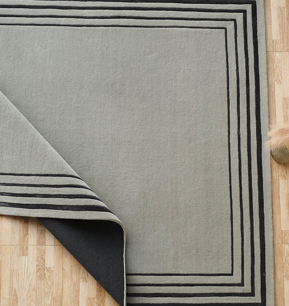 Overhead shot of the rectangular hand-tufted rug, showcasing the clean lines suitable for classic or contemporary furniture.