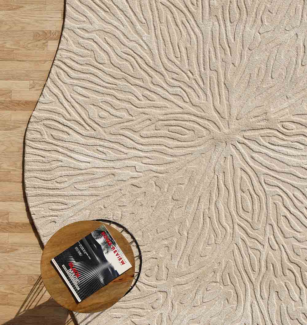Angled view of the shaped handmade rug, expertly crafted with natural fibers for a distinctive form.