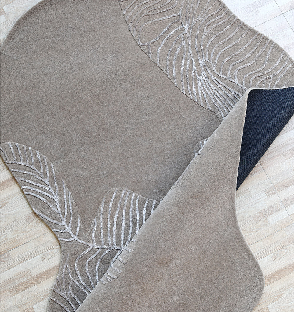 Angled top view of the handmade shaped rug and table, highlighting its superior quality and meticulous attention to detail.