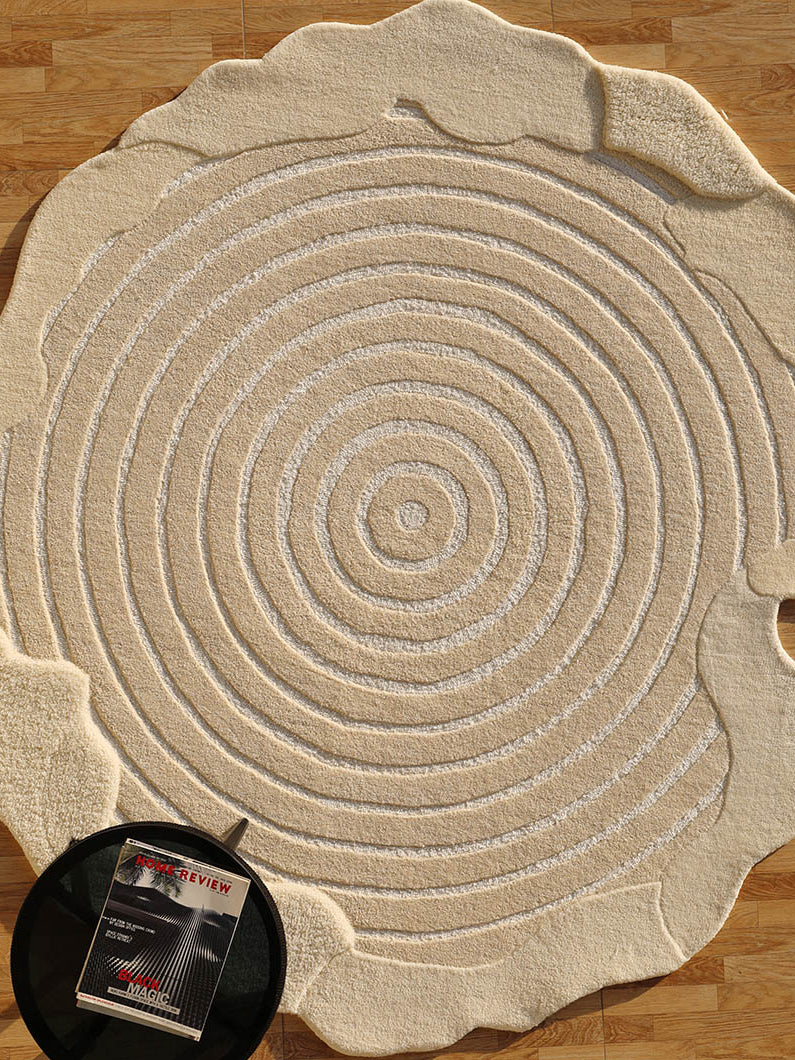 Textured shaped round handmade rug in beige, showcasing superior quality and luxurious texture.