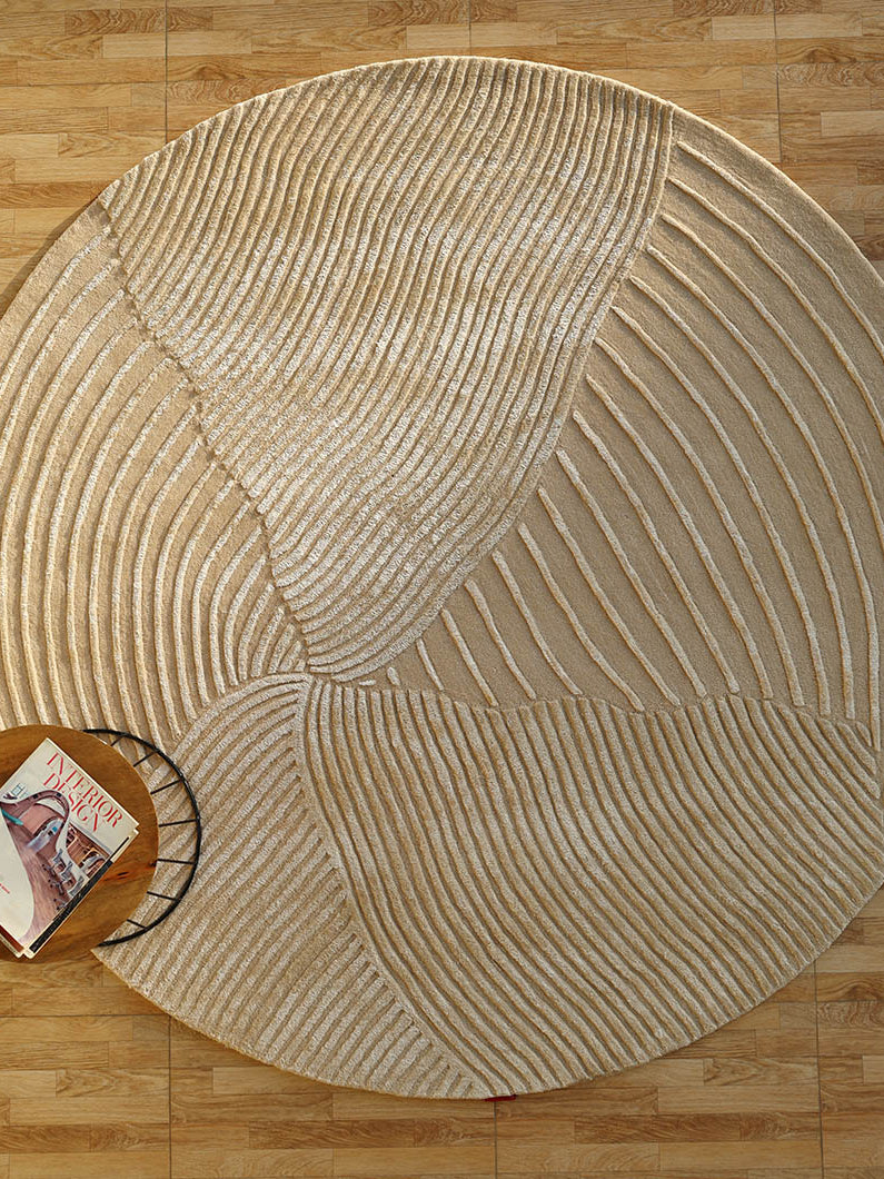 Beige textured round handmade area rug, showcasing superior quality and aesthetic sophistication with luxurious texture.