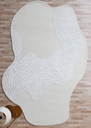 Textured leaf pattern handmade area rug in irregular shape, adding natural white aesthetic sophistication to the floor.