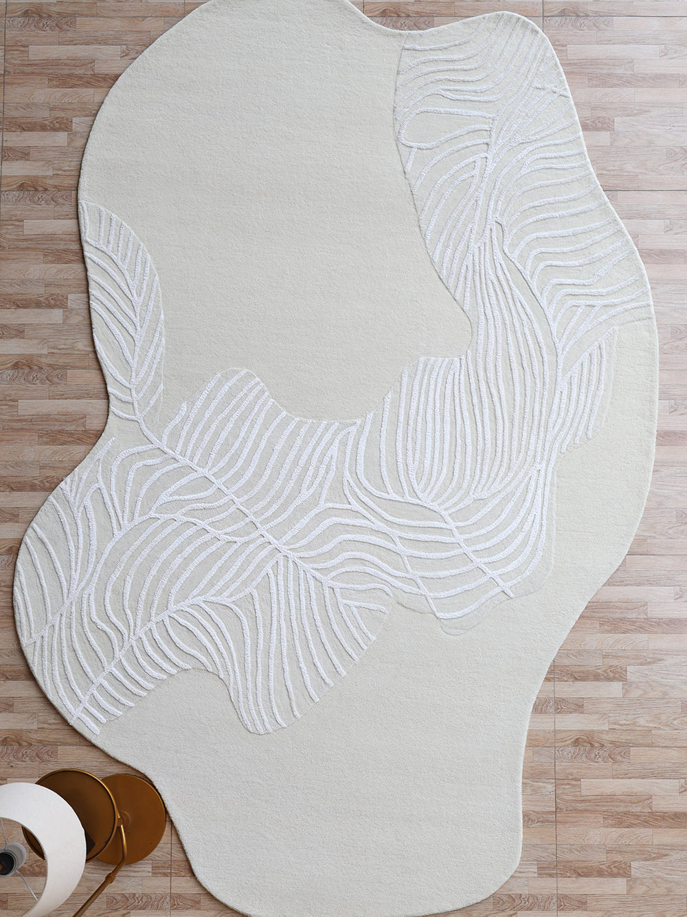 Textured leaf pattern handmade area rug in irregular shape, adding natural white aesthetic sophistication to the floor.