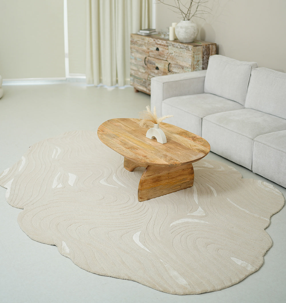 Organic shape flow line handmade rug anchoring a modern living room, showcasing aesthetic sophistication.