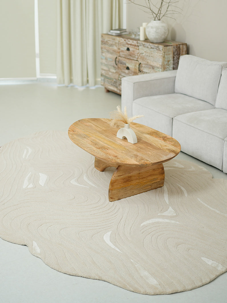 Organic shape flow line handmade rug anchoring a modern living room, showcasing aesthetic sophistication.