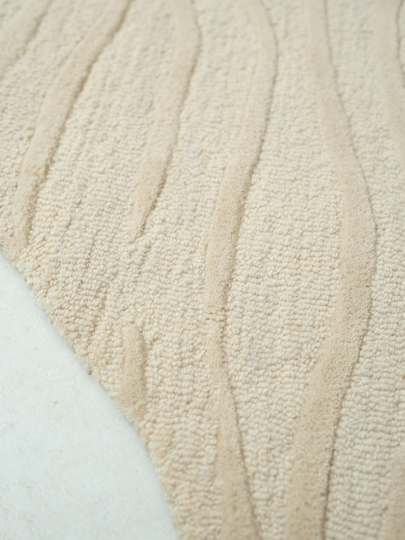 Close-up detailing the luxurious texture underfoot of the premium wool, viscose, and cotton fiber blend, crafted with meticulous attention.