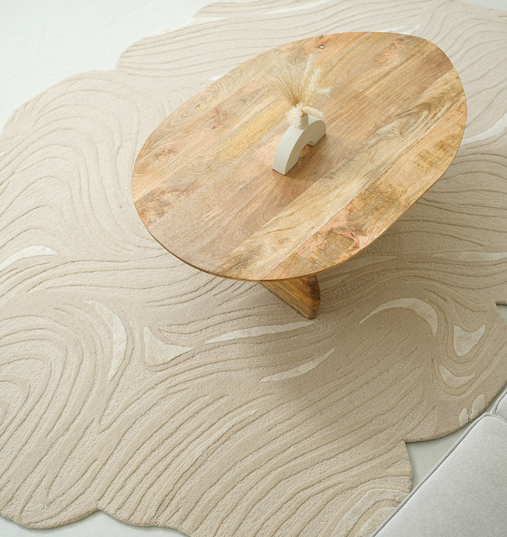 Organic shape flow line handmade rug anchoring a modern living room, showcasing aesthetic sophistication.