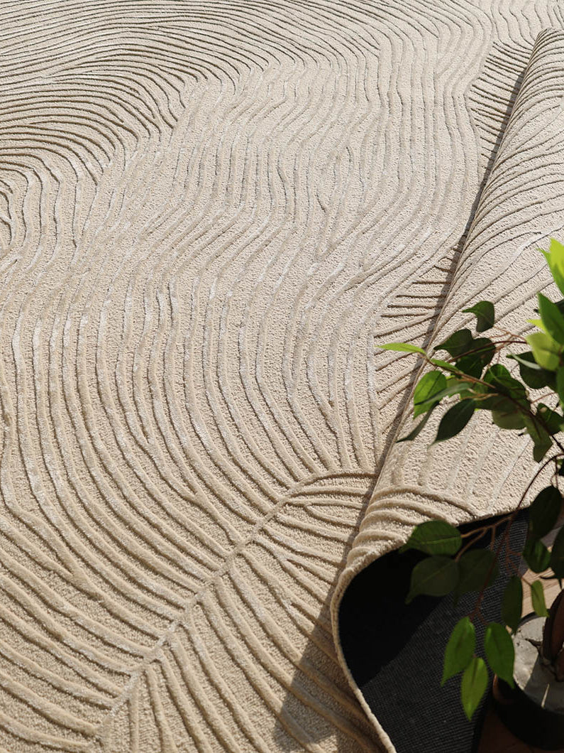 Close-up detailing the luxurious texture underfoot and the unique modern linear pattern of the natural white rug.
