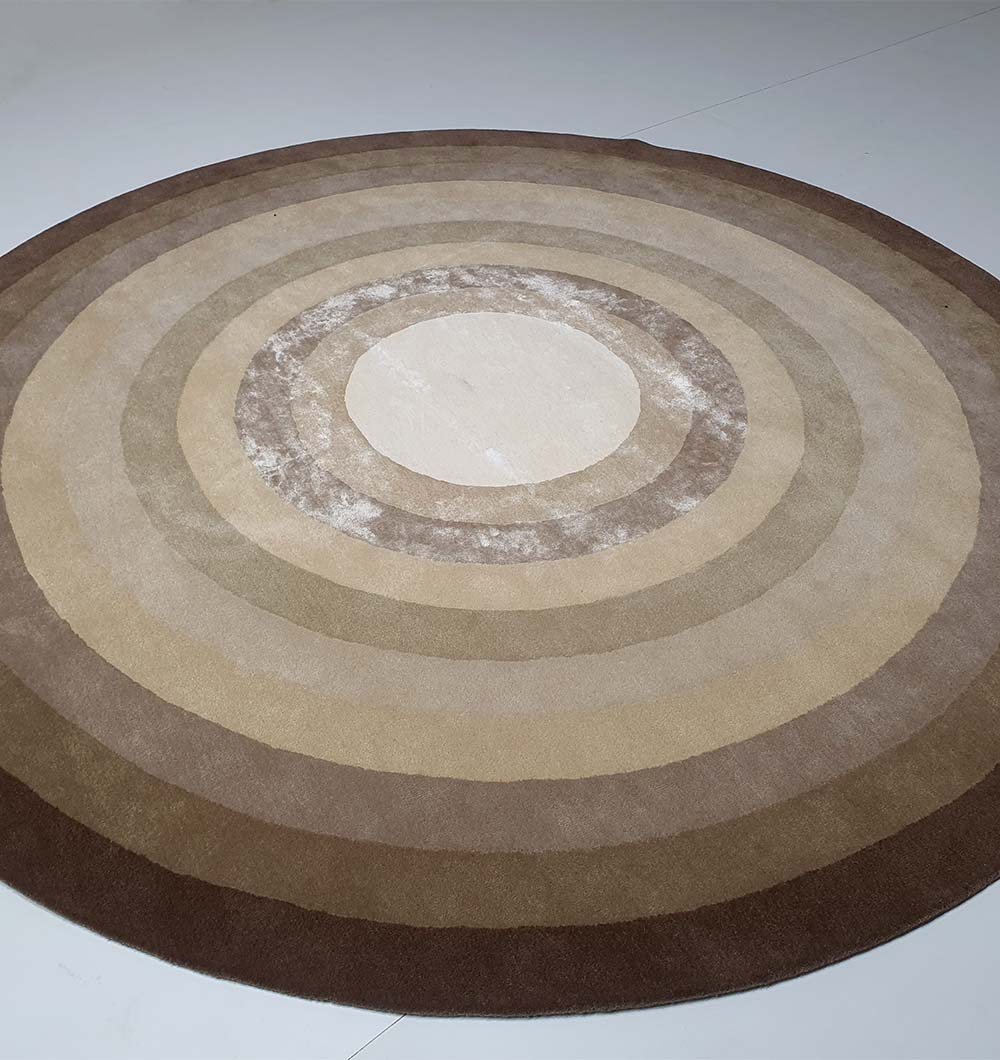 Side-angled view of the round rug, highlighting the dense pile height and the lustrous finish of the blended composition.