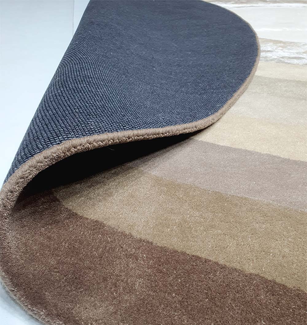Backside view of the round carpet, confirming the secure backing and hand-tufted structure for quality craftsmanship.